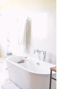 white drop-in bathtub near bath towel